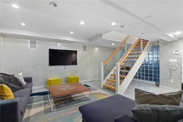 living area featuring recessed lighting, baseboards, concrete flooring, and stairs