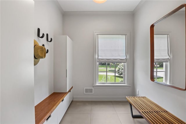 mudroom featuring light tile patterned flooring, visible vents, crown molding, and baseboards