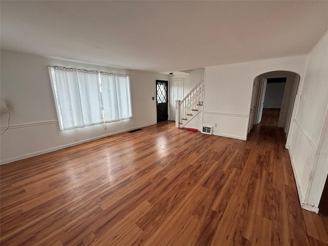 unfurnished living room with dark hardwood / wood-style floors