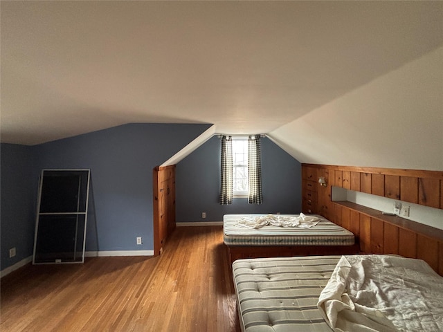 bedroom with lofted ceiling and hardwood / wood-style flooring