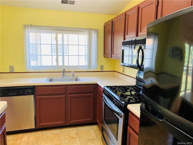 kitchen featuring sink, lofted ceiling, and black appliances