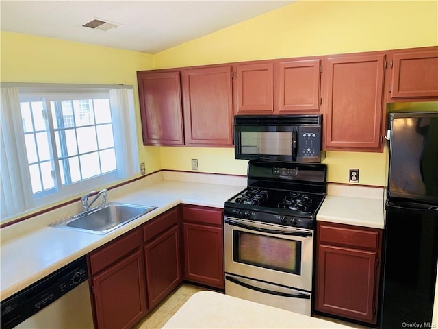 kitchen featuring sink, light tile patterned floors, black appliances, and lofted ceiling