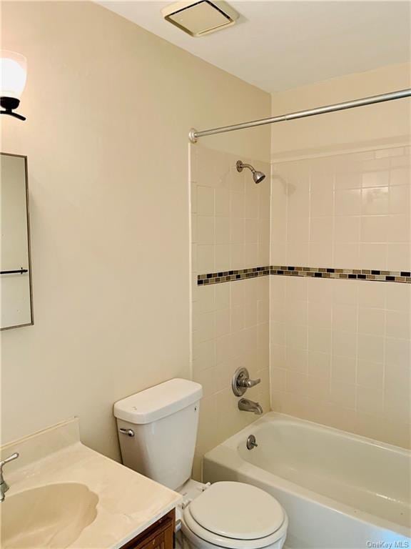 full bathroom featuring vanity, toilet, and tiled shower / bath combo