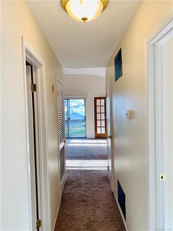 hallway with dark colored carpet