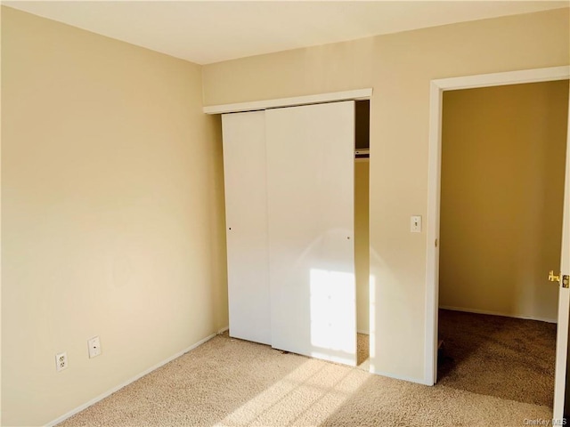 unfurnished bedroom with carpet and a closet