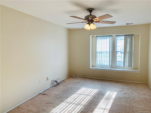 carpeted empty room featuring ceiling fan