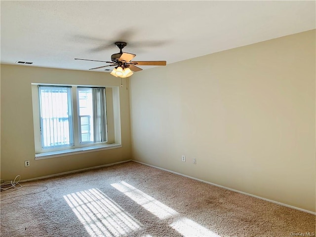 empty room featuring ceiling fan and carpet floors