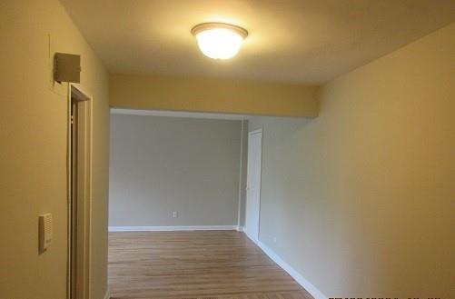 2244 Bronx Park E Unit 6L, Bronx, NY 10467 - hallway featuring wood finished floors and baseboards