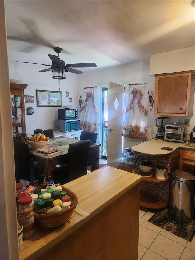 interior space featuring ceiling fan and light tile patterned flooring