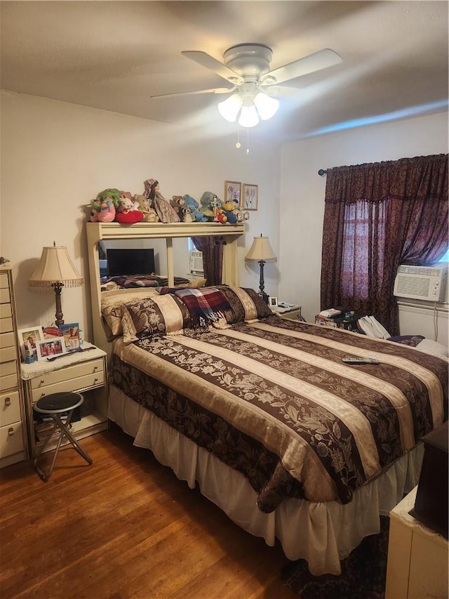 bedroom with wood-type flooring, ceiling fan, and cooling unit