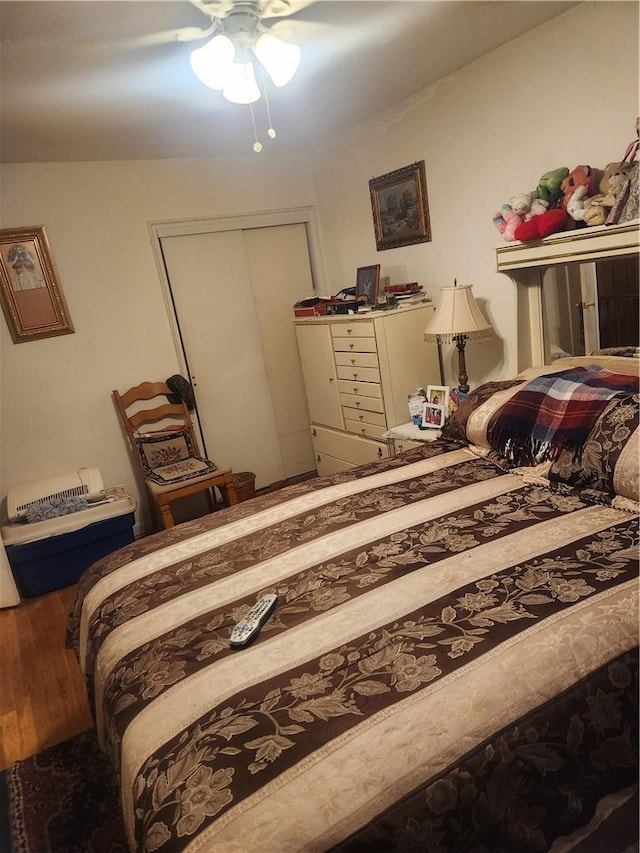 bedroom featuring wood-type flooring, a closet, and ceiling fan