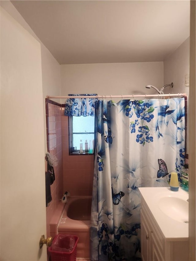 bathroom with vanity and shower / tub combo with curtain