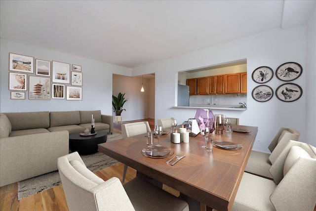 dining room with light wood-type flooring and sink