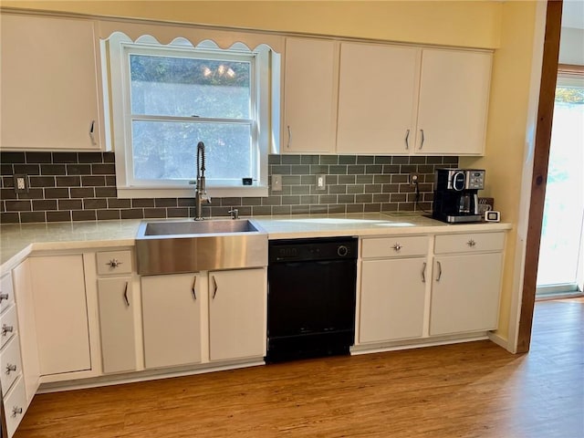 kitchen with dishwasher, white cabinetry, and light hardwood / wood-style flooring