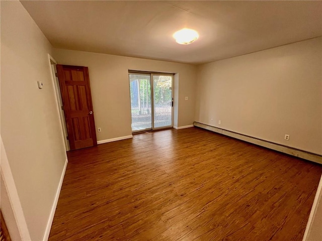 unfurnished room with dark wood-type flooring and a baseboard radiator