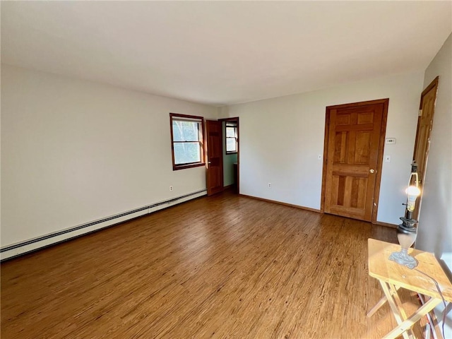 unfurnished room with light hardwood / wood-style flooring and baseboard heating