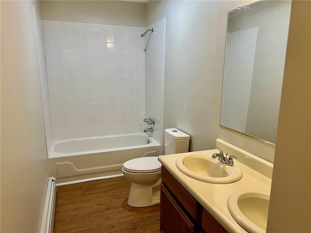 full bathroom featuring a baseboard heating unit, wood-type flooring, toilet, vanity, and tiled shower / bath