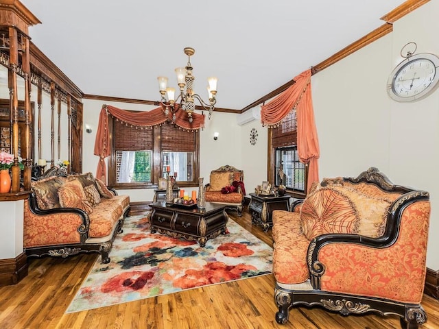 living room with wood-type flooring, crown molding, a wall mounted AC, and a notable chandelier