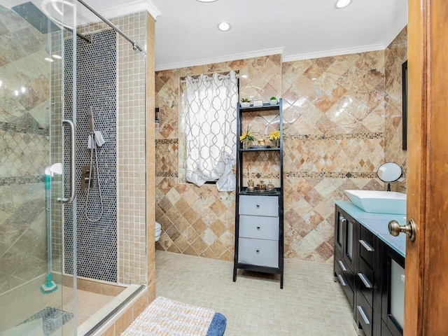 bathroom with crown molding, toilet, a shower with door, vanity, and tile walls