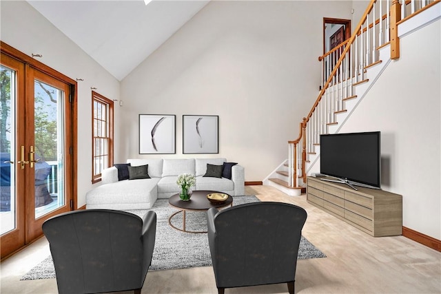 living room with light carpet, high vaulted ceiling, and french doors