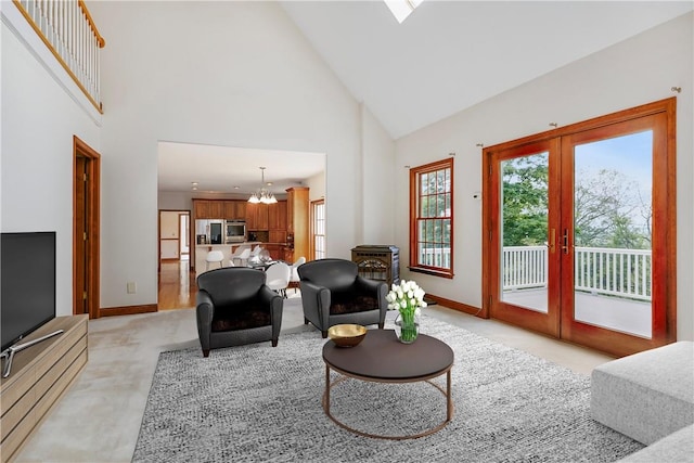 living room with french doors, high vaulted ceiling, and a chandelier