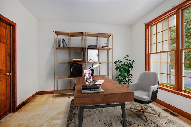 office area featuring light carpet and a healthy amount of sunlight