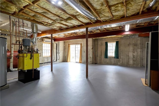 basement featuring a wall mounted AC and water heater