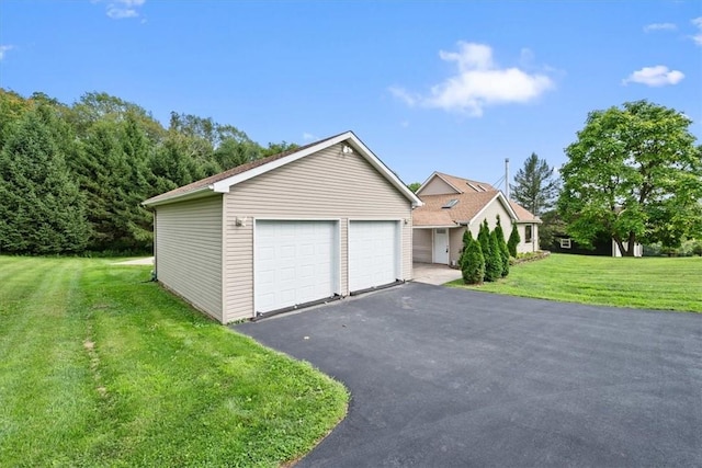 view of front of house with a front lawn, an outdoor structure, and a garage