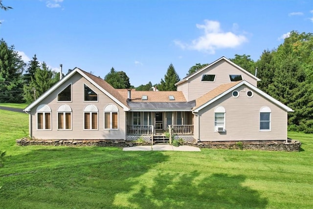 rear view of property featuring a patio, a lawn, cooling unit, and a sunroom