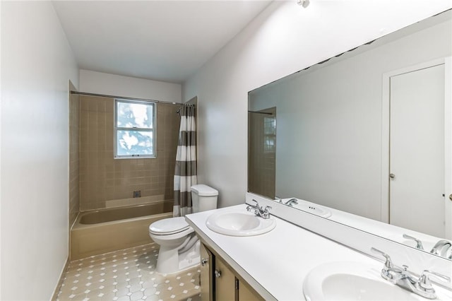 full bathroom featuring tile patterned flooring, shower / bath combination with curtain, vanity, and toilet