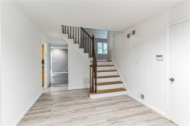 staircase with wood-type flooring