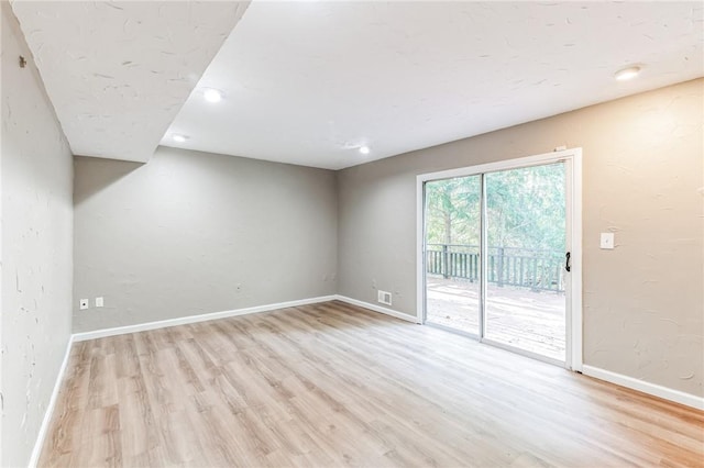 empty room with light hardwood / wood-style flooring