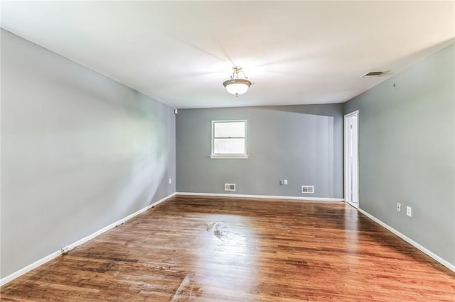 spare room with hardwood / wood-style floors