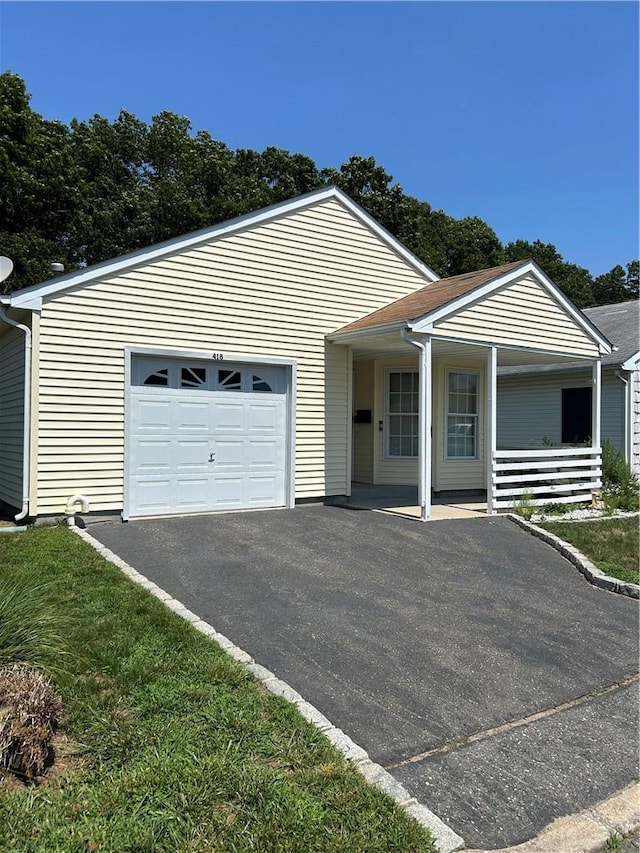 ranch-style home with a garage and covered porch