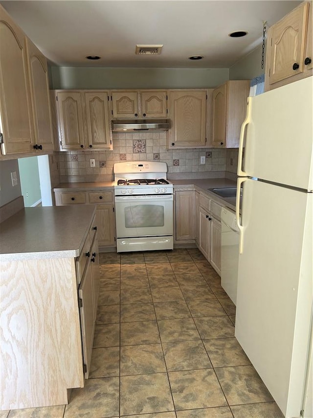 kitchen with light brown cabinetry, white appliances, tile patterned floors, and backsplash