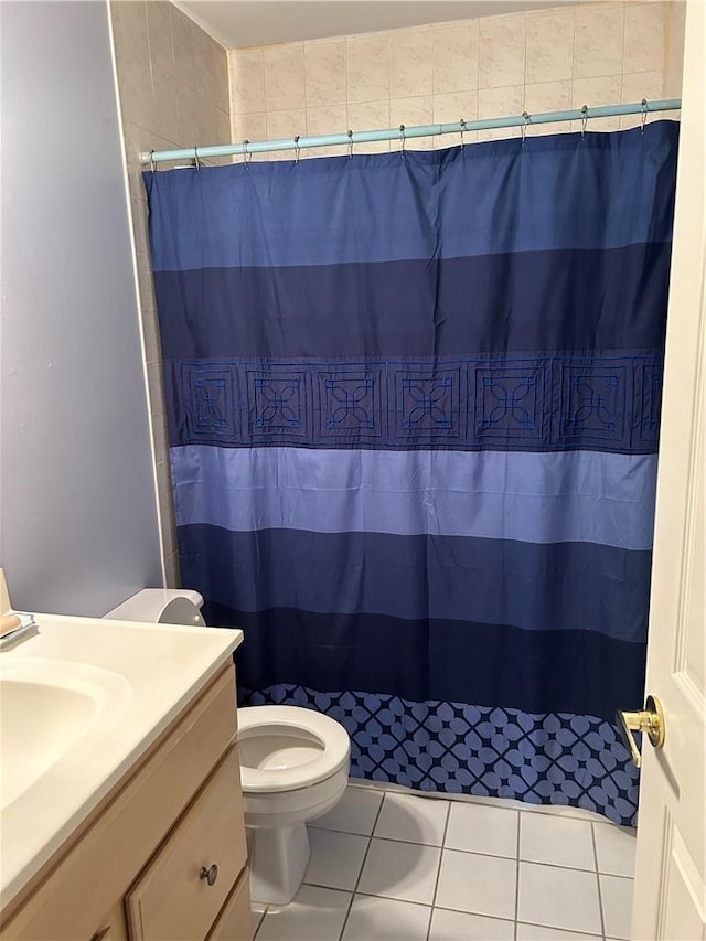 bathroom featuring curtained shower, tile patterned flooring, vanity, and toilet