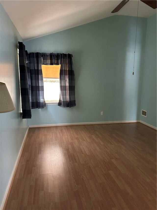 empty room with hardwood / wood-style floors, ceiling fan, and lofted ceiling