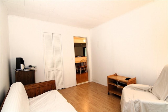 bedroom with a closet and light hardwood / wood-style flooring