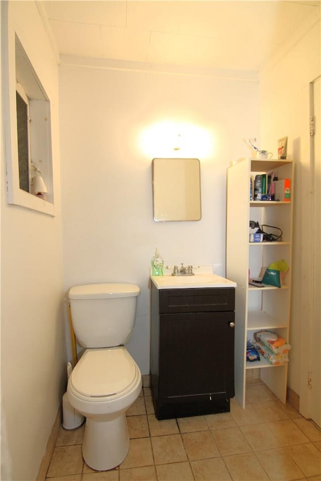 bathroom with tile patterned flooring, vanity, and toilet