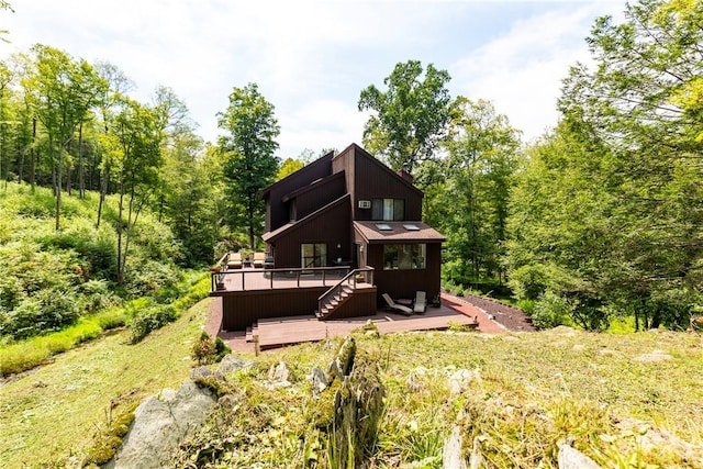 back of property with a wooden deck