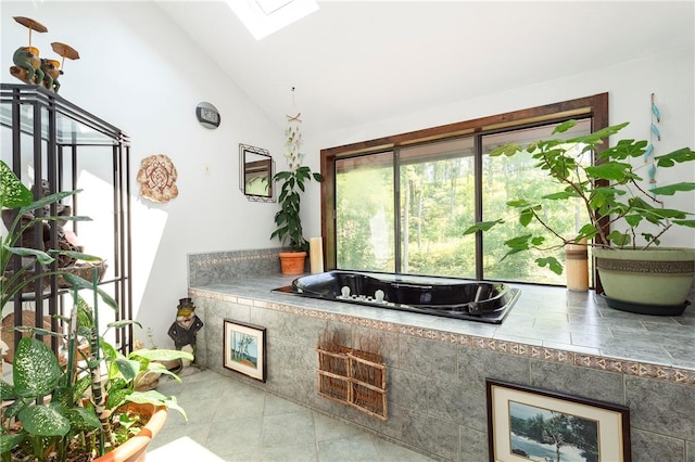 bathroom featuring vaulted ceiling with skylight