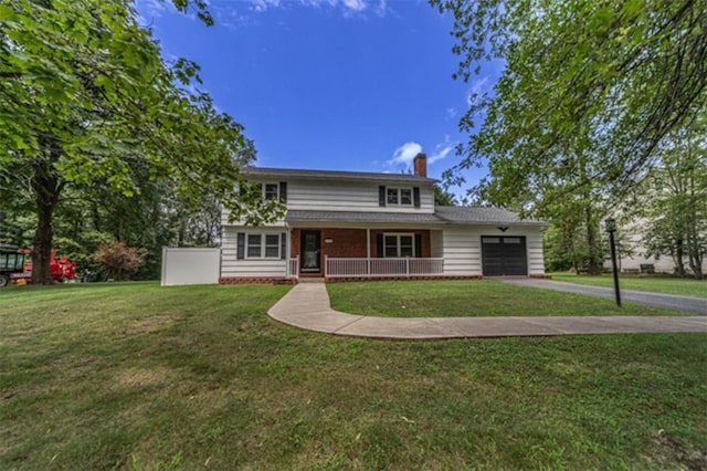 view of front of home featuring a front lawn, a porch, and a garage