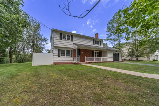 view of front facade with a front yard, a porch, and a garage