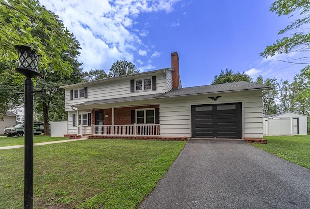 view of front facade featuring covered porch, a garage, and a front yard