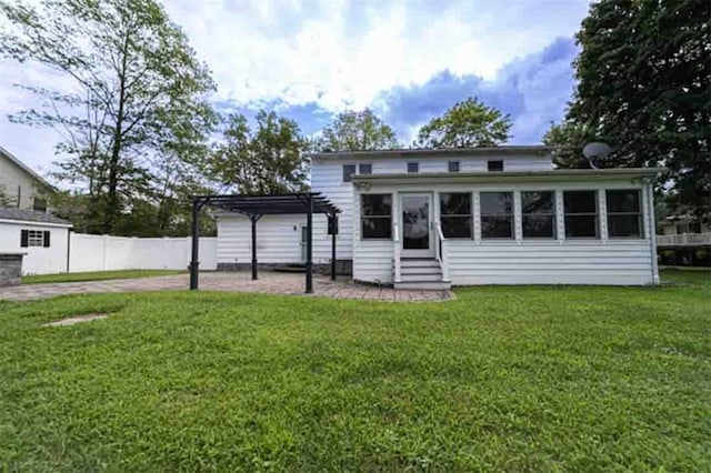 back of house with a pergola and a lawn