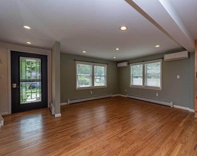 foyer with light wood-type flooring, a wealth of natural light, and a baseboard radiator