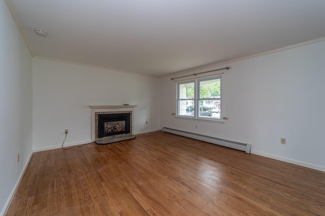 unfurnished living room featuring a fireplace, hardwood / wood-style floors, a baseboard radiator, and ornamental molding