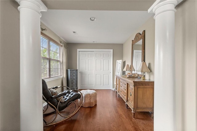 sitting room featuring ornate columns and hardwood / wood-style flooring