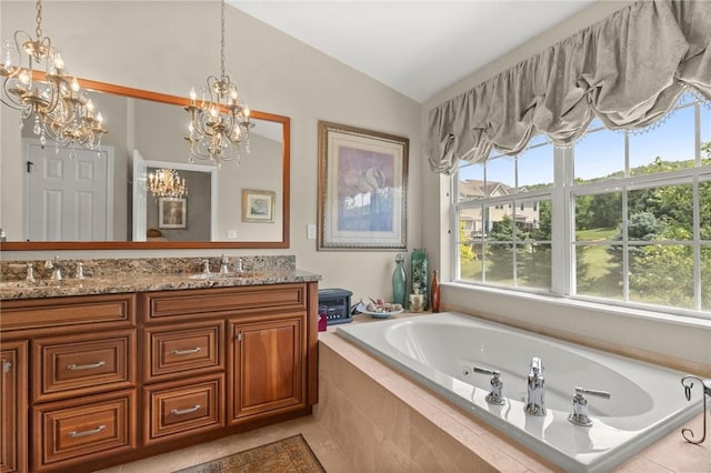 bathroom featuring tile patterned flooring, tiled tub, a chandelier, lofted ceiling, and vanity