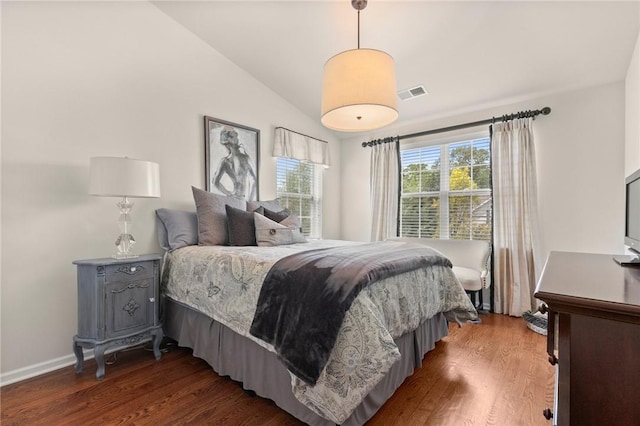 bedroom with vaulted ceiling and dark hardwood / wood-style floors